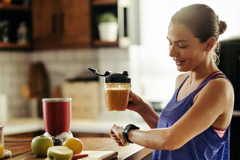 Image of a person standing in the kitchen in the morning
